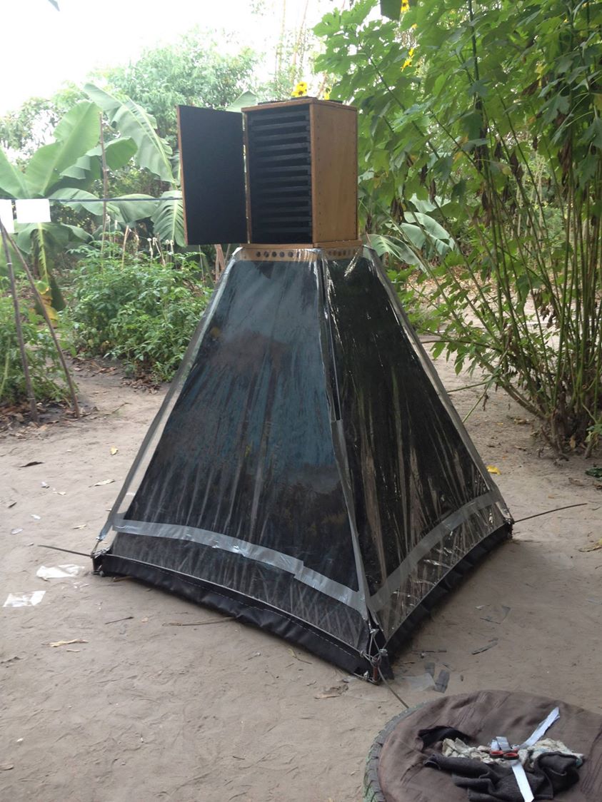 Local metalworker welding with sparks flying, ornate iron gates in background
